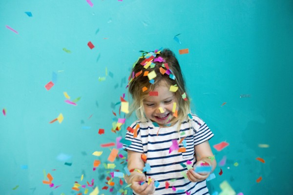 Colorful confetti falling on Caucasian girl