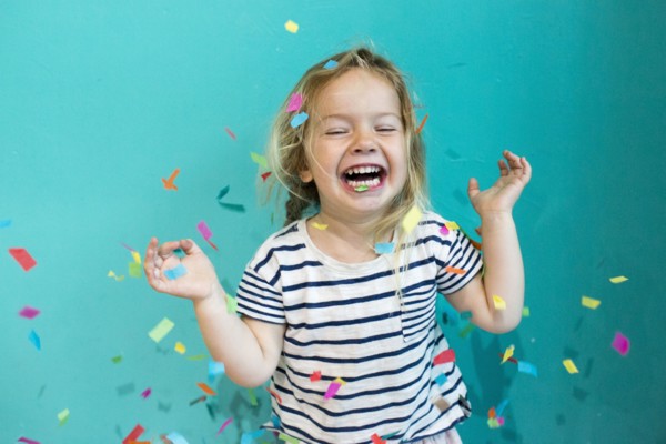 Colorful confetti falling on Caucasian girl
