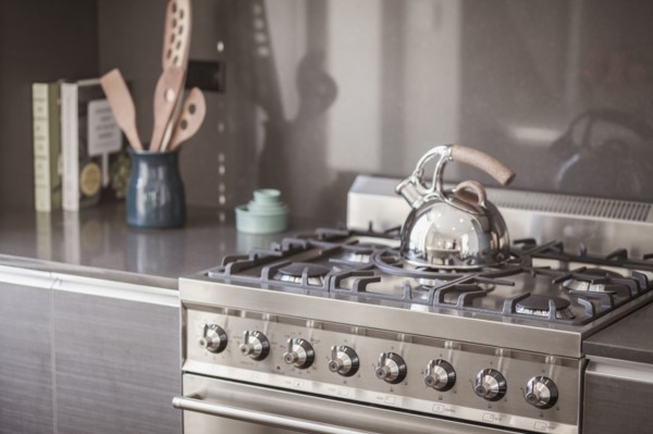 Kettle on stainless steel stove in modern kitchen