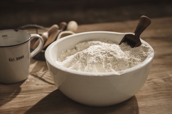 Close up of bowl of flour with scoop