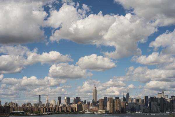 New York City skyline under cloudy blue sky
