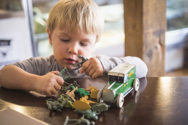Caucasian boy playing with toys on table