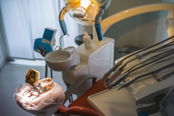 Empty chair and dentures in office of dentist