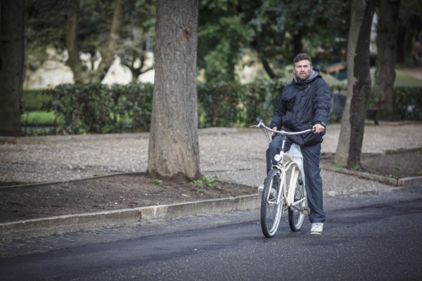 Caucasian man riding bicycle on street