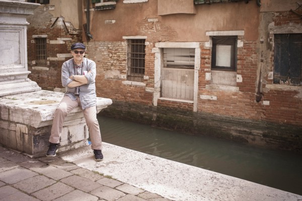 Caucasian tourist standing on canal waterfront