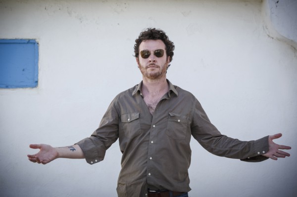 Caucasian man standing with arms outstretched outdoors
