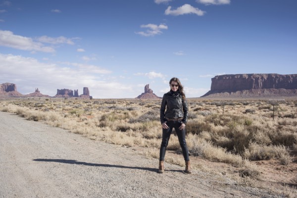 Caucasian woman standing on desert dirt road
