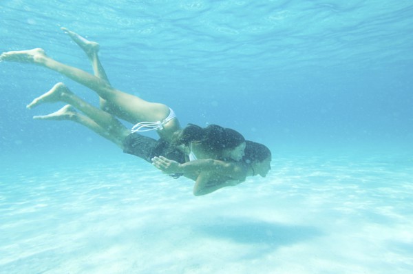 Underwater view of couple swimming in ocean