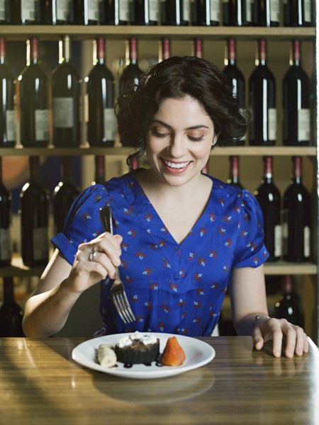 Caucasian woman eating dessert in restaurant