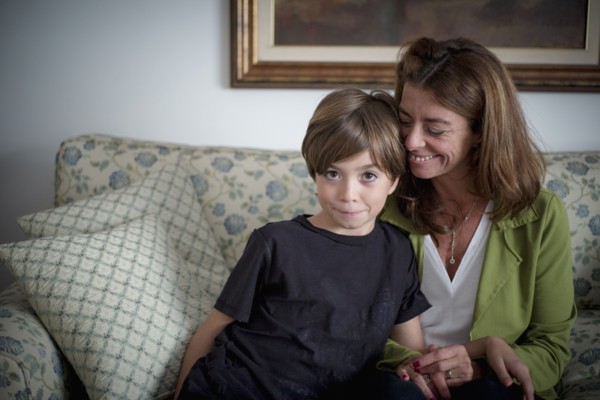 Caucasian grandmother and grandson sitting on sofa