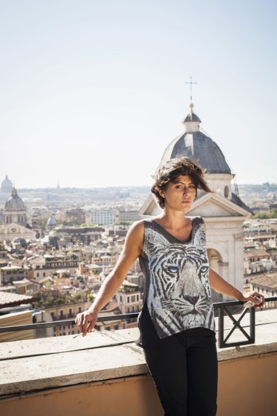 Caucasian woman standing on urban rooftop