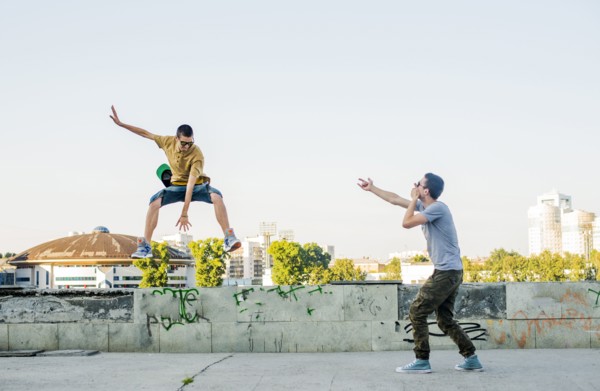 Caucasian men jumping in city
