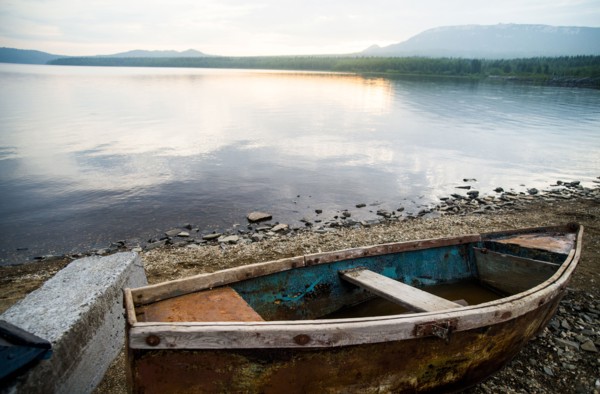 Dilapidated boat at rural lake