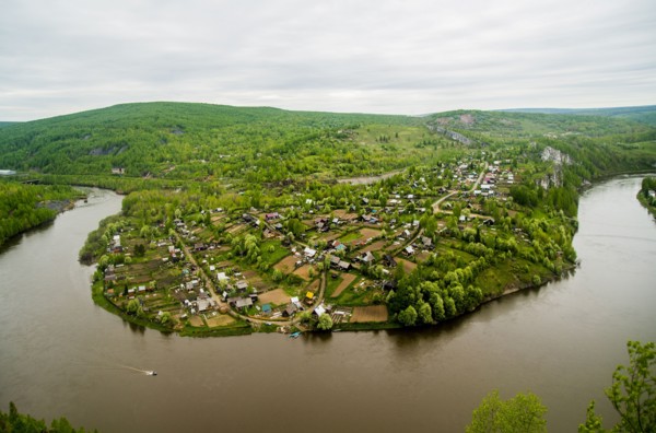 Aerial view of village near bend in river