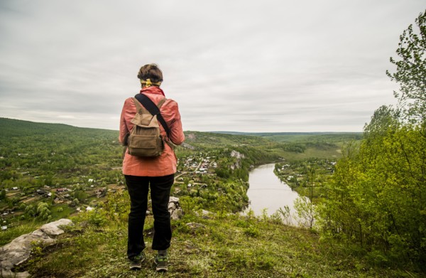 Caucasian hiker admiring scenic view of village
