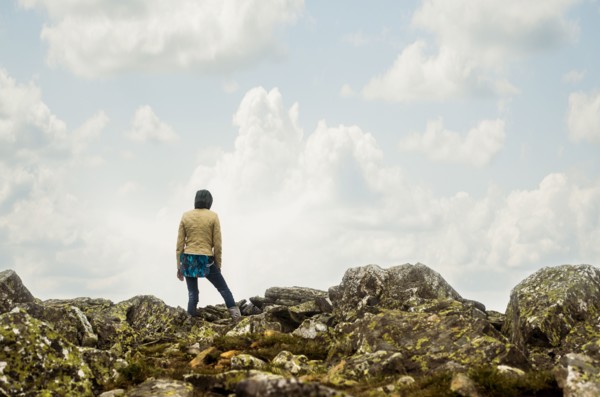 Caucasian hiker standing on rocky hilltop