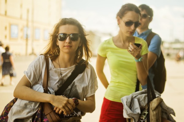 Caucasian women carrying bags outdoors