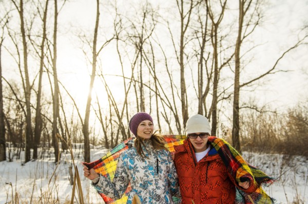 Caucasian couple wrapped in blanket outdoors