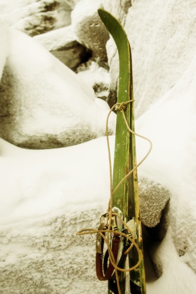 Close up of skis leaning on snowy rock formations