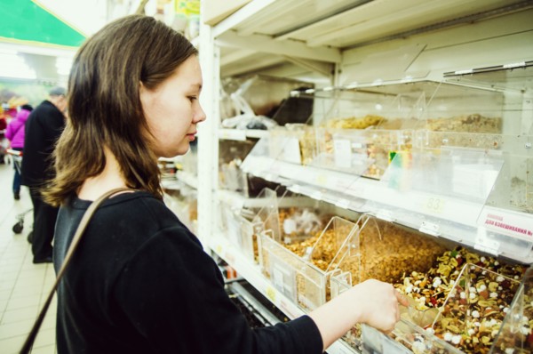 Caucasian woman shopping in grocery store