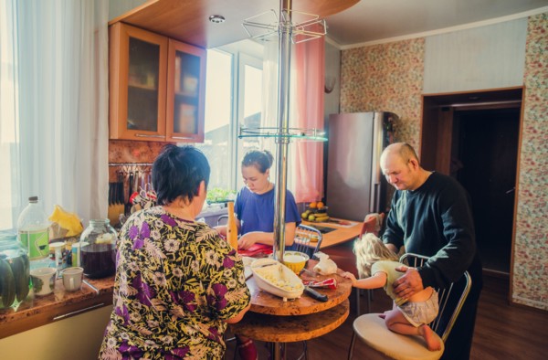 Caucasian family cooking in kitchen