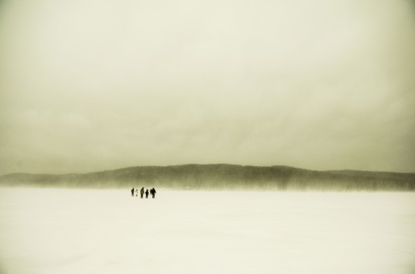 Caucasian hikers walking in snowy remote field