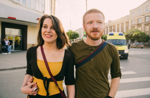 Caucasian couple crossing city intersection