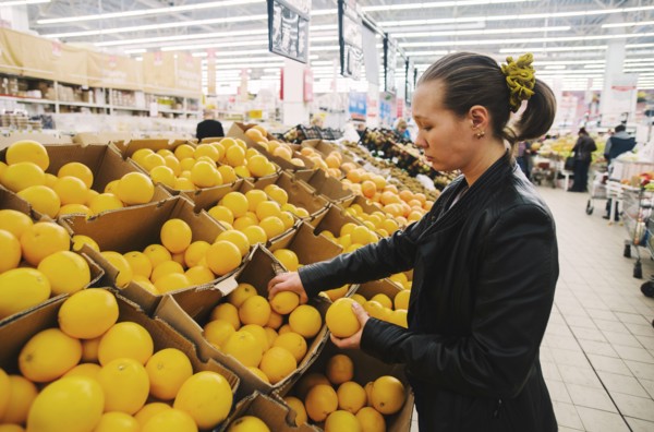 Caucasian woman shopping in grocery store