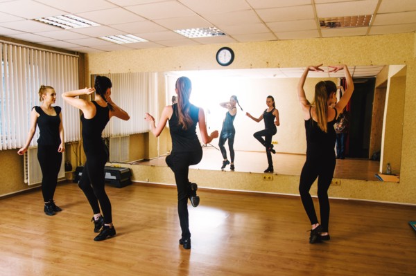 Caucasian dancers practicing in studio