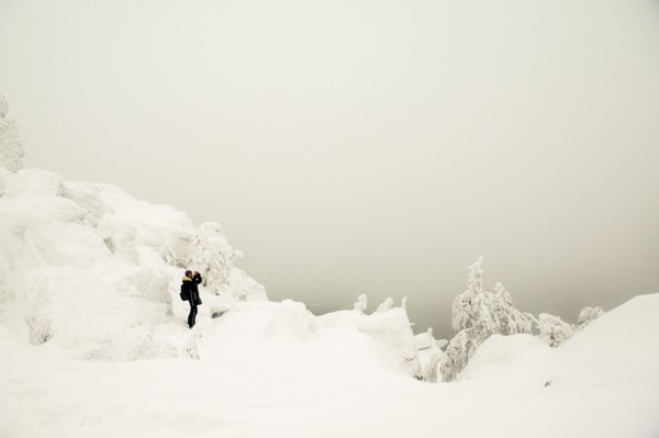 Hiker walking in snowy forest