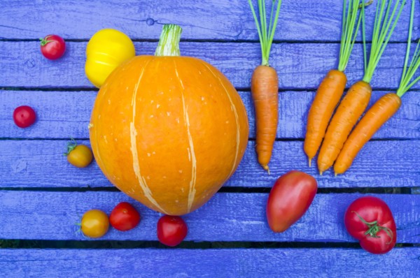 Fresh vegetables on purple wooden table