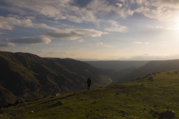 Distant Caucasian man admiring scenic view of valley