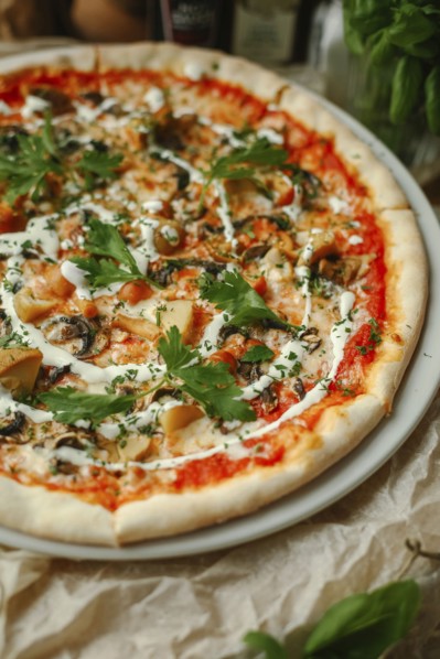 Gourmet pizza with basil on plate