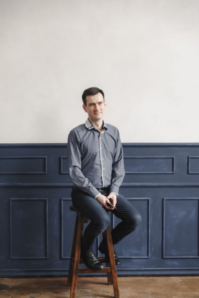 Portrait of Middle Eastern man sitting on stool