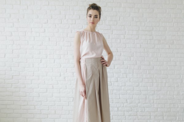 Portrait of glamorous Middle Eastern woman standing near wall
