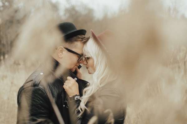 Middle Eastern couple rubbing noses in field
