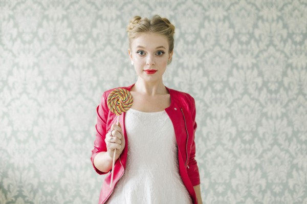 Middle Eastern woman holding lollipop