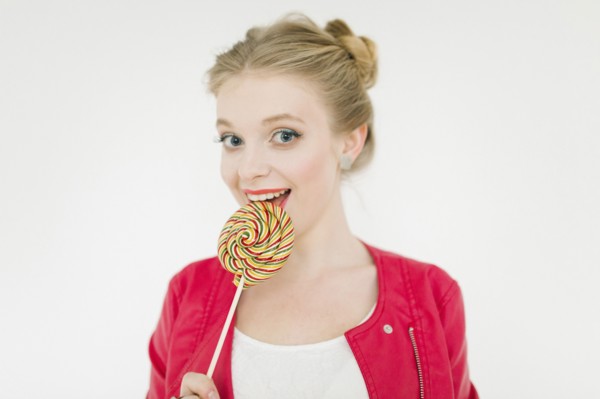 Middle Eastern woman eating lollipop