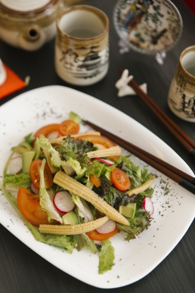 Chopsticks on plate of salad