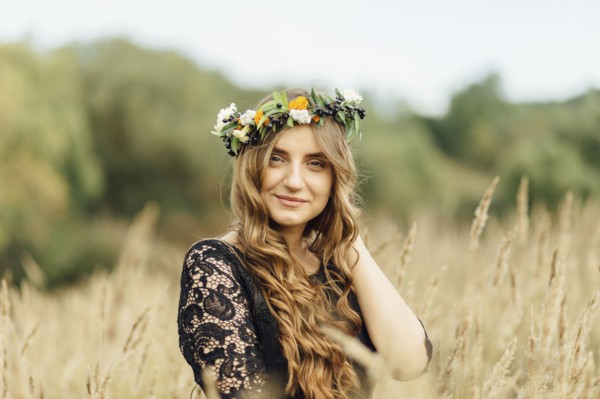 Middle Eastern woman wearing flower crown in field