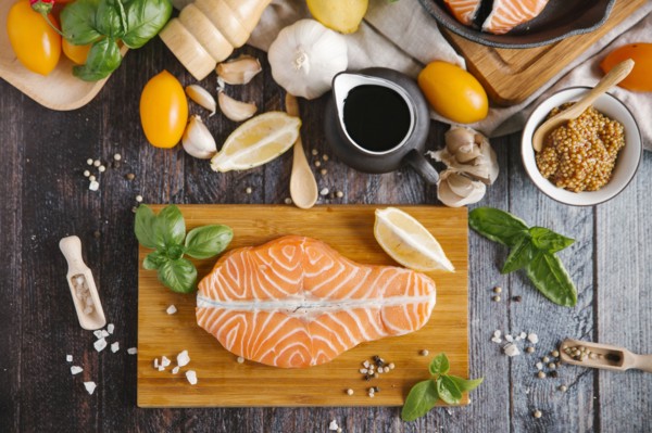 Raw salmon on cutting board with ingredients