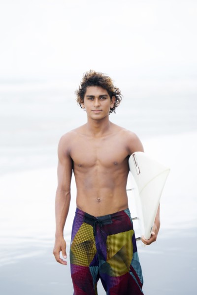 Man carrying surfboard on beach