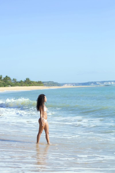 Mixed race woman walking on beach