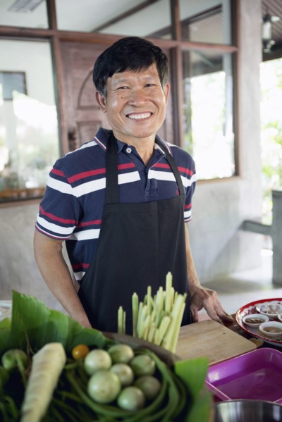 Smiling Thai man preparing food