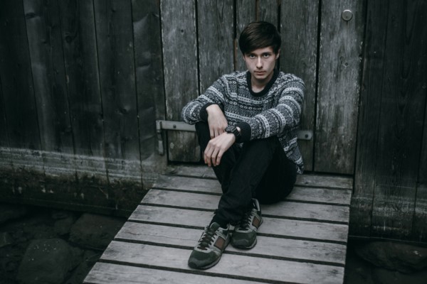 Caucasian man sitting on wooden dock