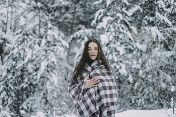 Portrait of Caucasian woman in snowy forest