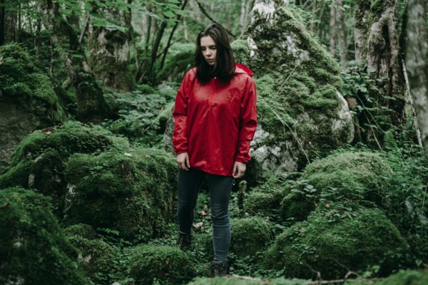 Caucasian woman standing in lush forest