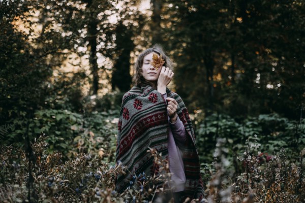 Caucasian woman holding autumn leaf