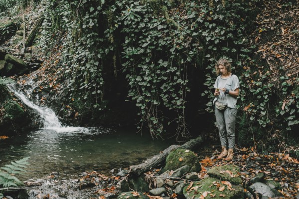 Caucasian woman standing near forest stream