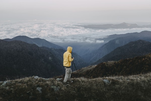 Caucasian man photographing in remote mountain landscape